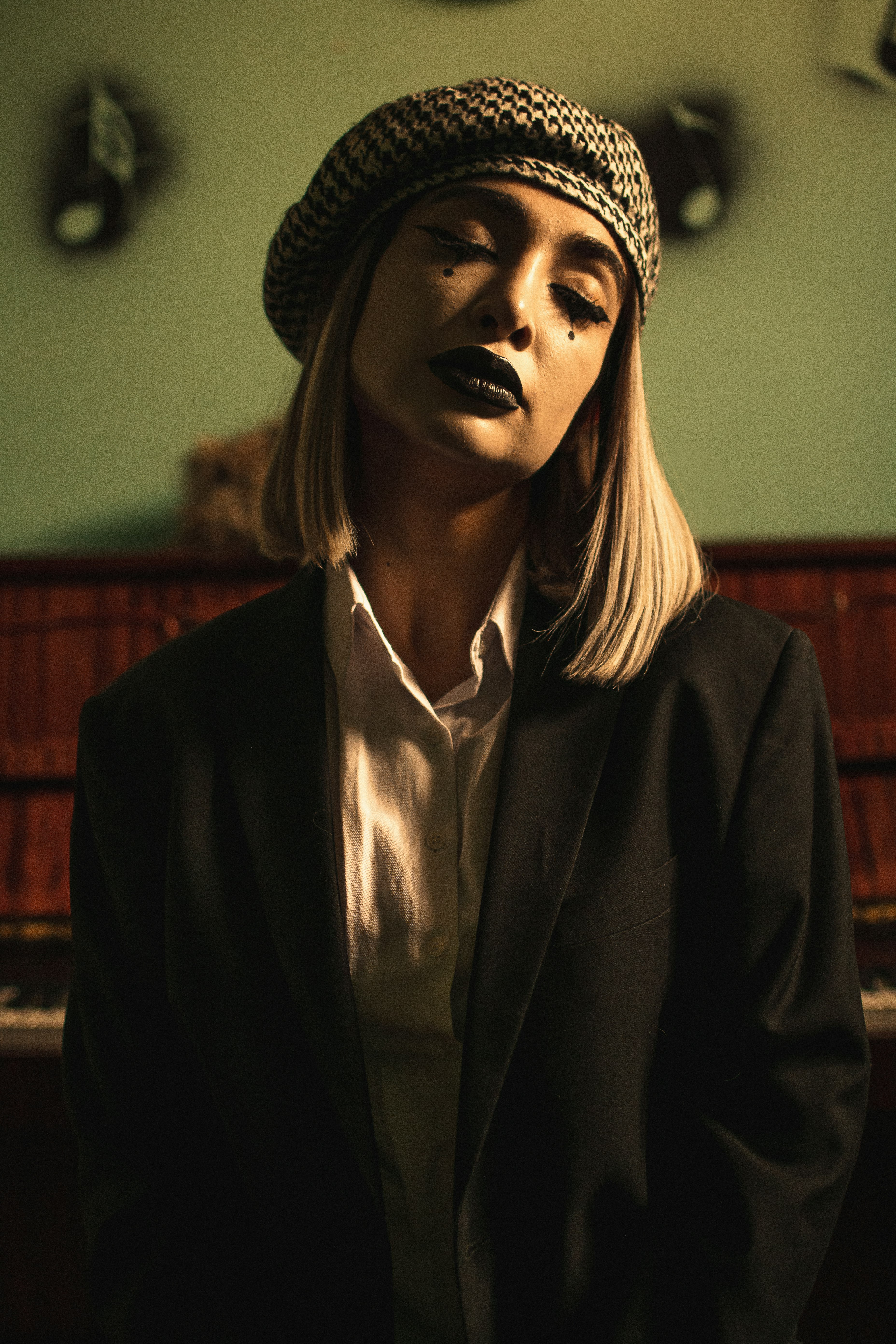 woman in black blazer wearing white earbuds